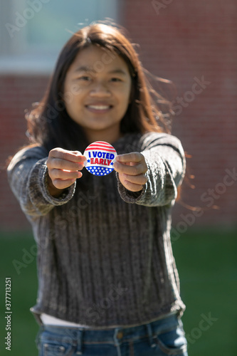 Cute Taiwanese woman Voter holding an Early Voting Sticker