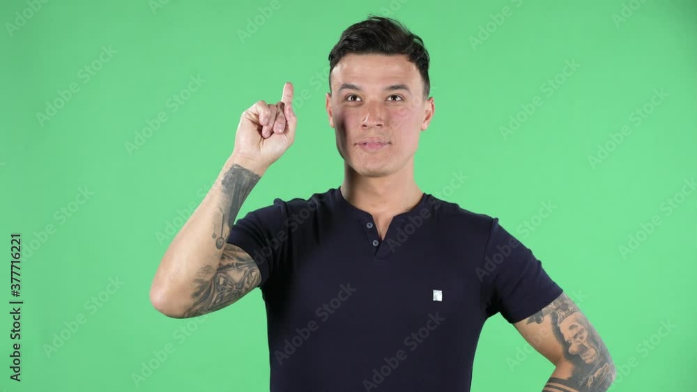 Portrait of a handsome young guy is thinking about something, and then an idea coming to him. Green screen. Portrait of a handsome young guy is thinking about something, and then an idea coming to him. Green screen.