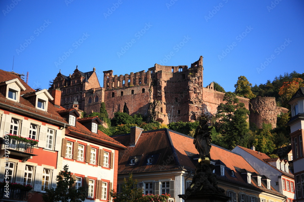 View of old town the corn market and Heidelberg castle ruins with Madonna statue during autumn in Heidelberg, Germany