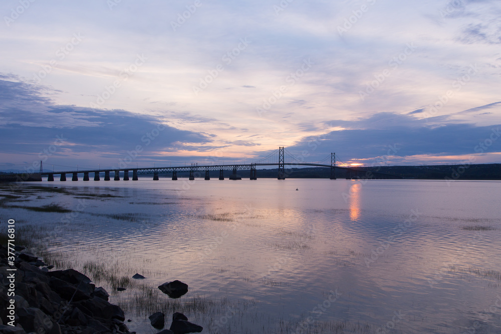 The 1935 Island of Orleans Bridge over the St. Lawrence River seen in silhouette at dawn, Quebec City, Quebec, Canada