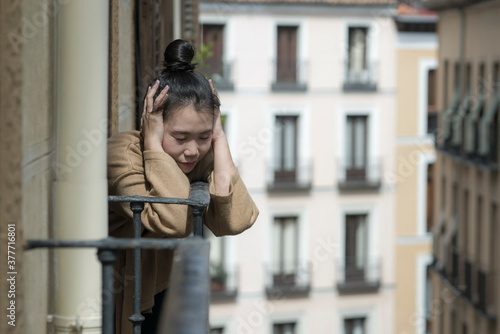 dramatic portrait of young beautiful sad and depressed Asian Chinese woman feeling unhappy and worried suffering some problem going through depression and anxiety crisis