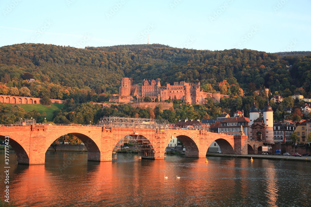 View of Heidelberg old town and Castle with Old Bridge over the river Neckar during sunset in autumn in Heidelberg, Germany