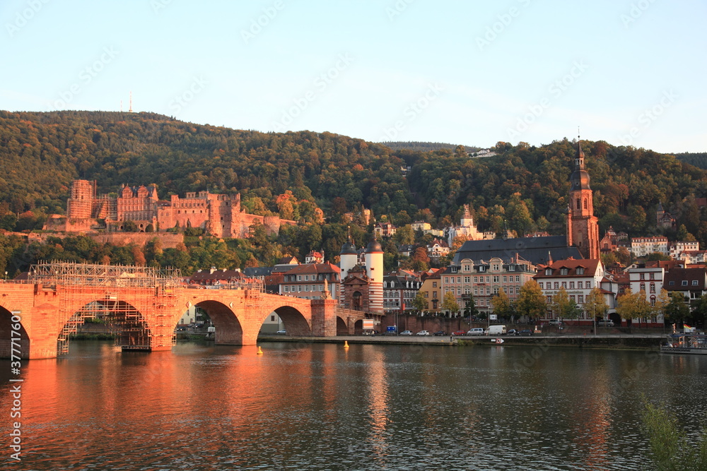 View of Heidelberg old town and Castle with Old Bridge over the river Neckar during sunset in autumn in Heidelberg, Germany