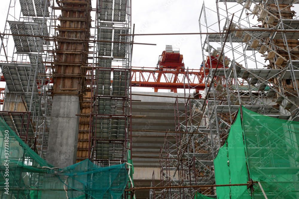 SEREMBAN, MALAYSIA -MAY 24, 2020: Temporary access and metal staircase made from staging, scaffolding and metal platform. Workers used it at the construction site to work at height. 