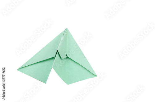 A green origami plane on departure