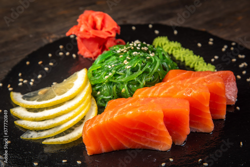 Salmon sashimi on black dish