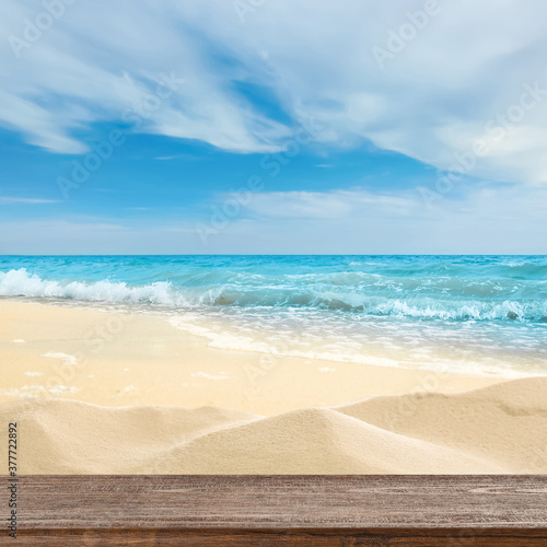 Wooden surface on sandy beach near ocean