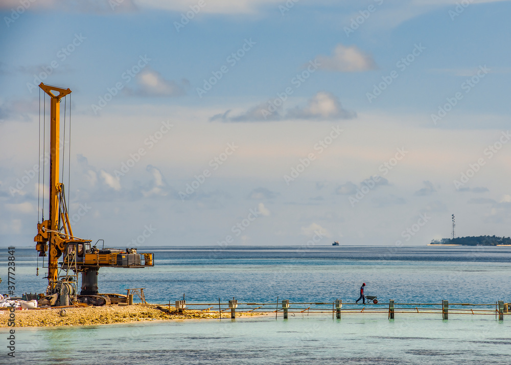 Construction machine on the Maldives island in the Indian ocean