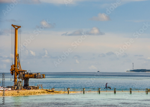 Construction machine on the Maldives island in the Indian ocean © Sergey