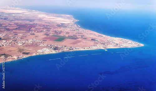 Aerial view of Cyprus island surrounded by azure sea with waves