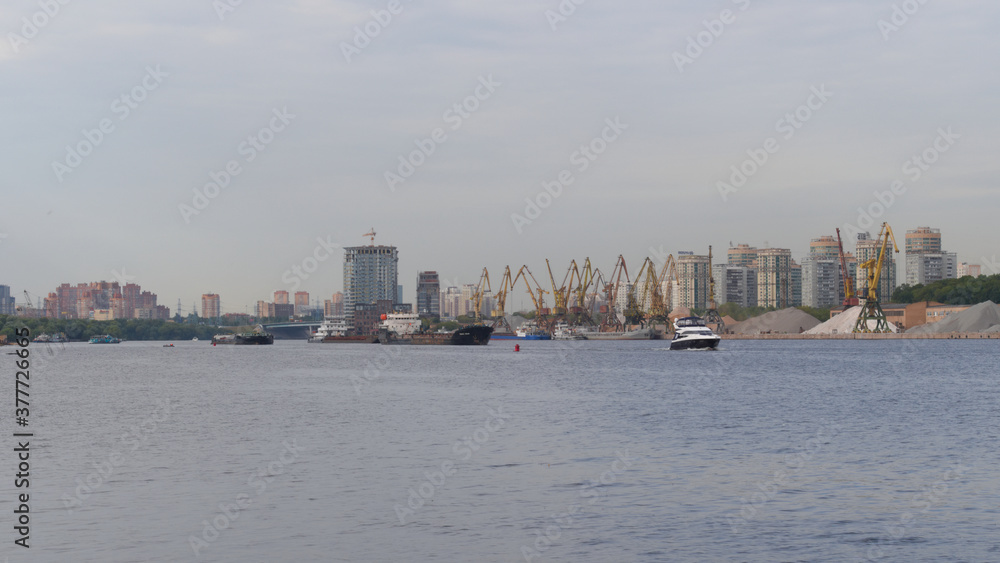 Cargo cranes and river transport in Moscow. Khimki reservoir