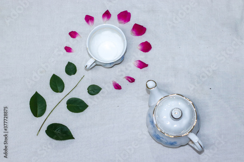 empty tea and saucer with rose petals