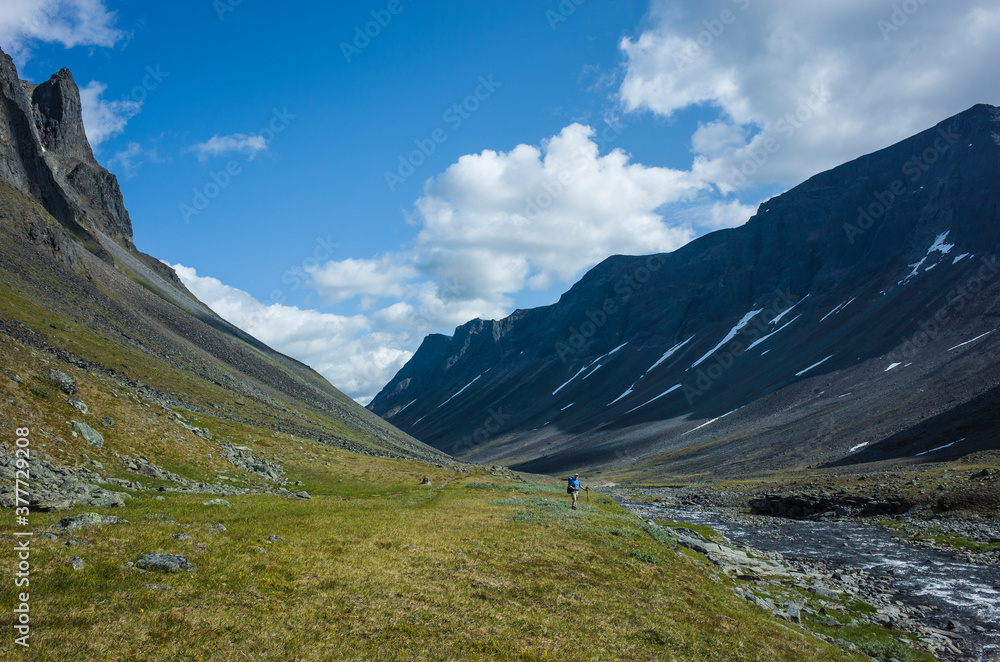 Hiking in Swedish Lapland. Man trekking alone in northern Sweden. View of Nallo mountain, Arctic nature of Scandinavia in summer day