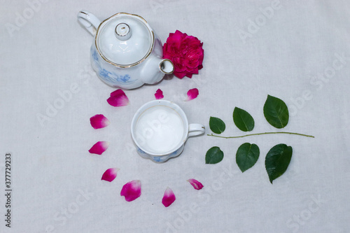 empty tea and saucer with rose petals
