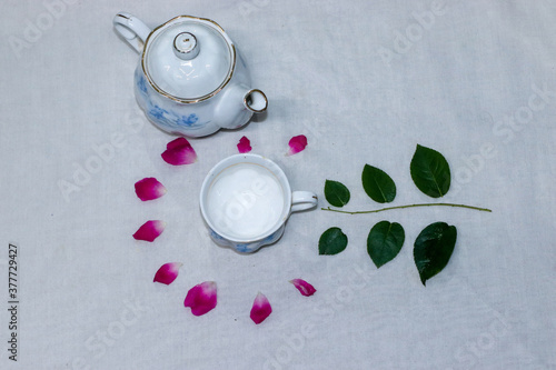 empty tea and saucer with rose petals