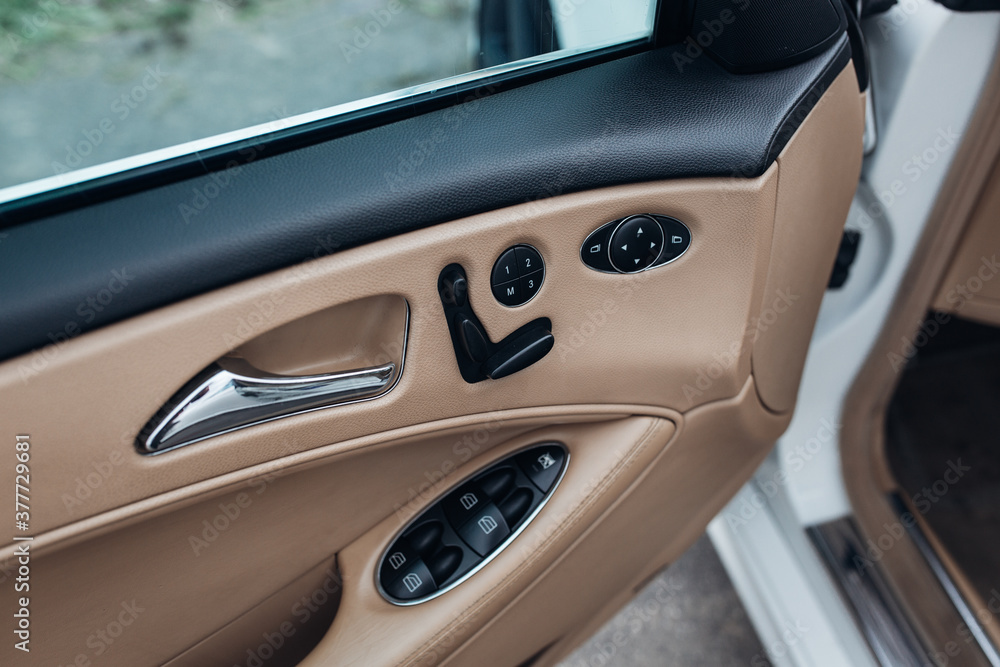 Car door handle with central locking and windows control buttons inside the car