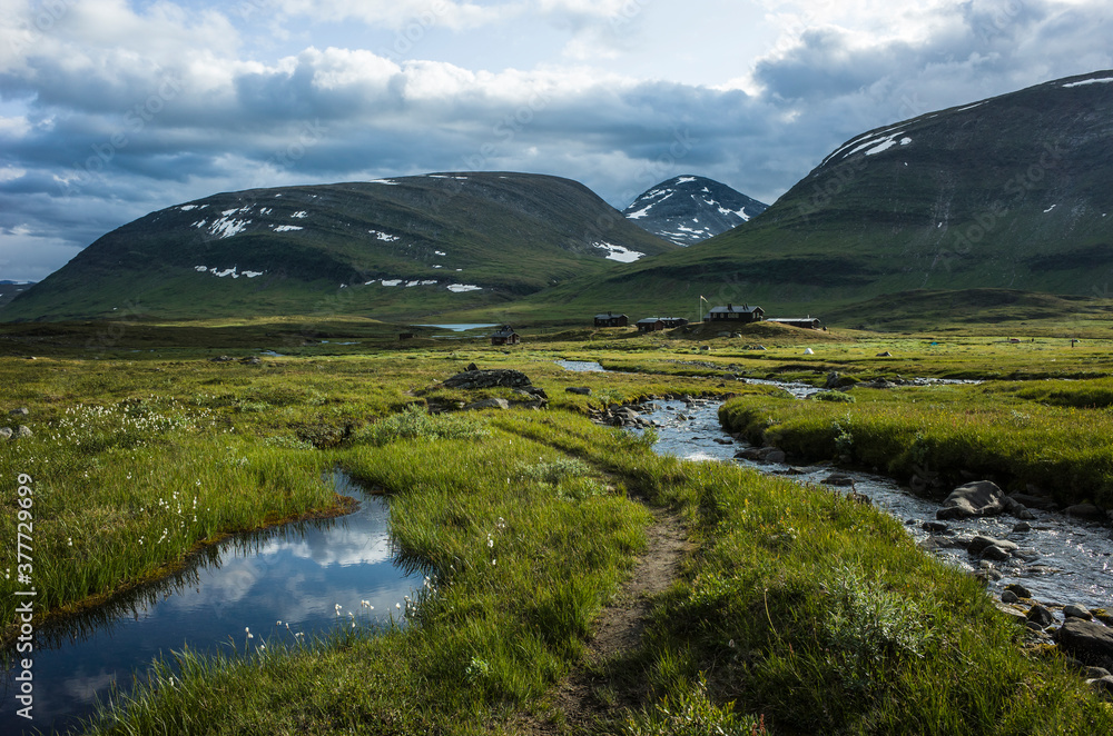 Picturesque Swedish Lapland landscape. Salka Mountain Huts along the King's trail in northern Sweden. Arctic mountain environment of Scandinavia in summer day