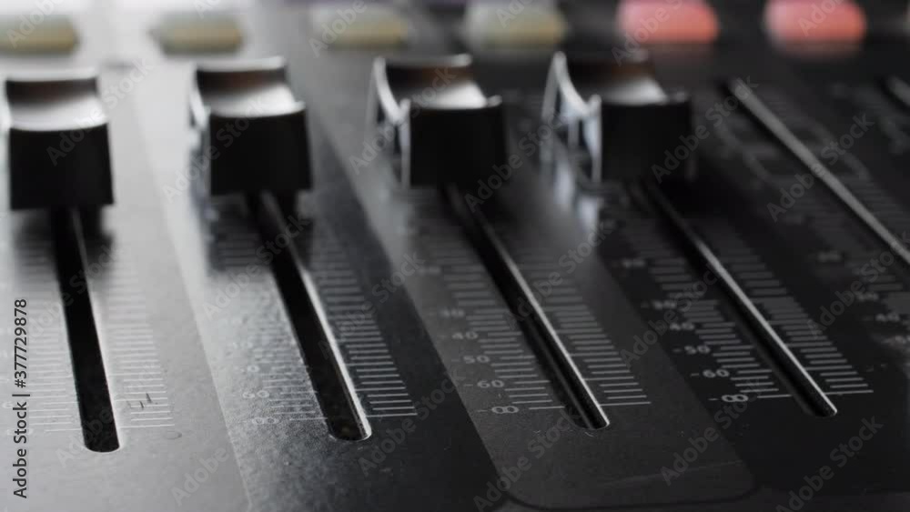 Digital audio console. Motorized sliders. Close up. Digital audio console. Motorized sliders. Close up.