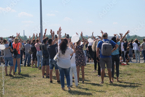 Group of aircraft fans gathered at airport festival and cheering up