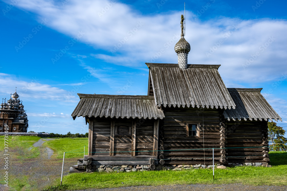 rural landscape with a mill, wooden church and old buildings on the island