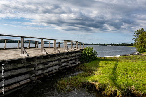 rural scenery with gray wooden pier on island