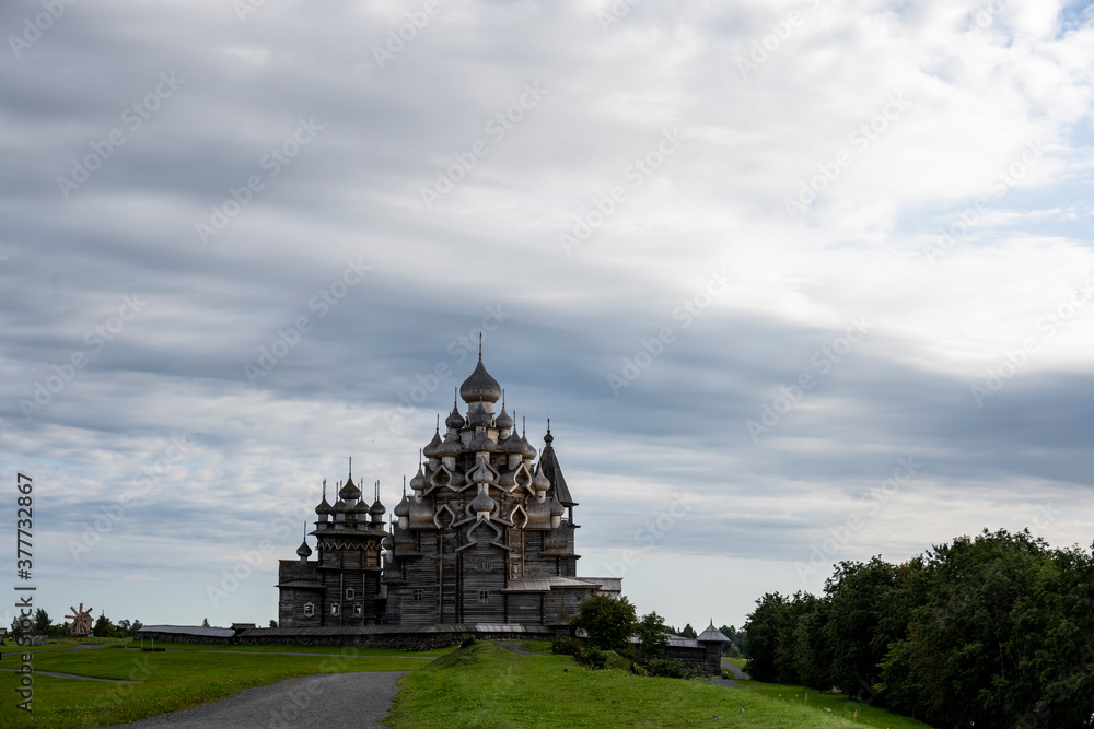 old wooden architectural complex with towers temples on a green island