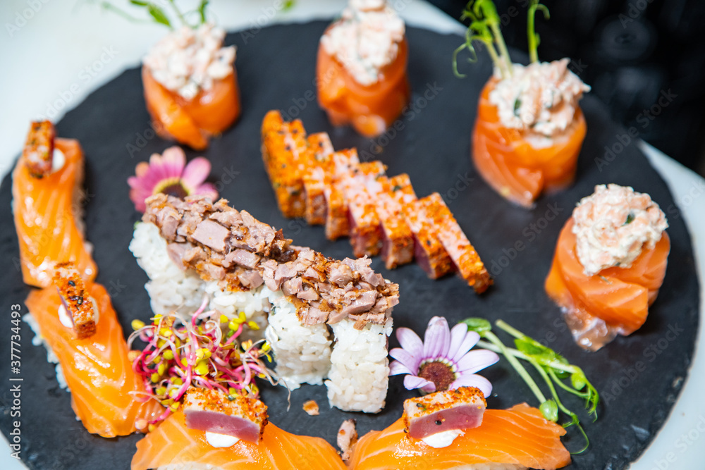 Closeup of chef hands preparing japanese food. Japanese chef making sushi at restaurant.