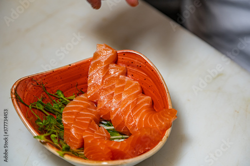 Closeup of chef hands preparing japanese food. Japanese chef making sushi at restaurant. 