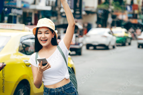 Asian traveller woman relax journey with smartphone in Bangkok city.