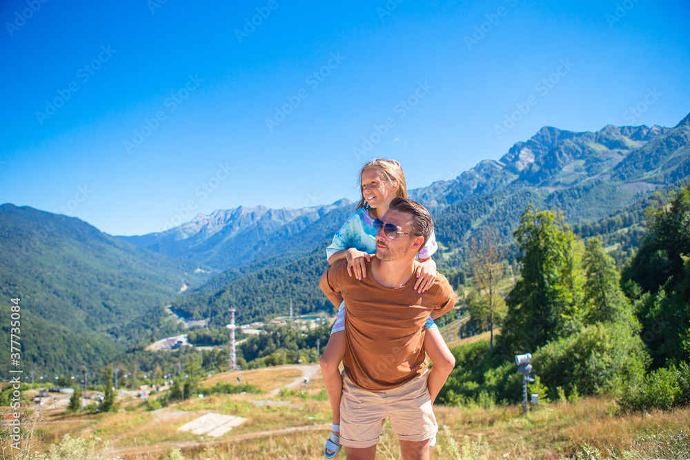 Beautiful happy family in mountains in the background