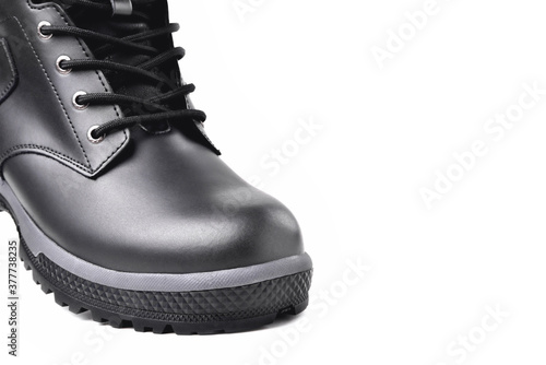 Winter male black leather boot on a white background, hiking shoes, practical off-road shoes, close-up details of the model