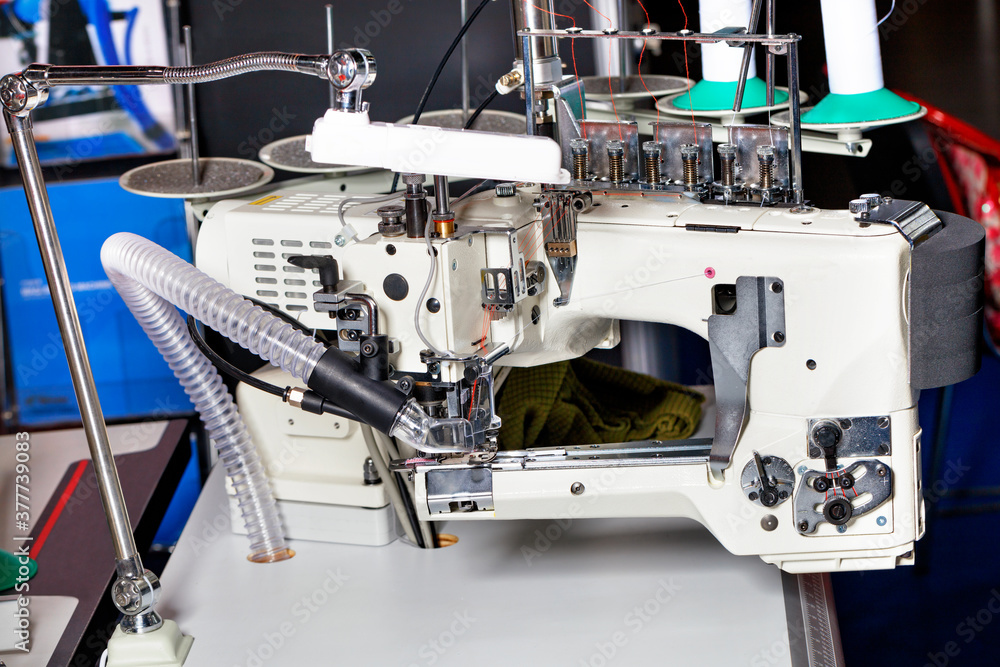 Professional overlock knitting and sewing machine, sewing equipment, close-up.
