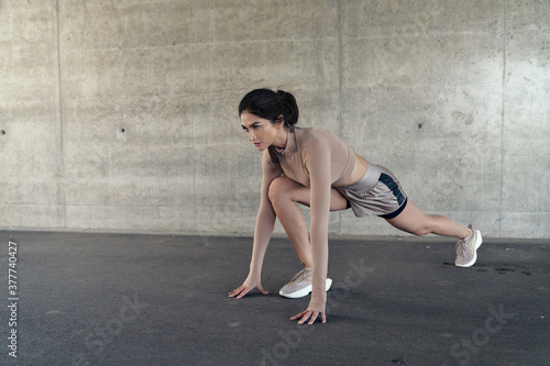 Portrait of a brunette, sensual lady doing the stretching