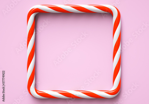 Classic red and white striped christmas candy color frame on pink background. Frame with copy space for candy bar. 3D rendering and 3D illustration.