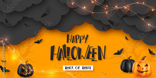 Happy Halloween horizontal banner. Pumpkins with monster faces, paper clouds, flying bats and garland. Handwritten lettering, orange background. Vector illustration.