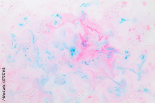 Fluid art texture. Pink blue background from liquid. Photography of colored spots on liquid. Abstract pattern © Lazartivan