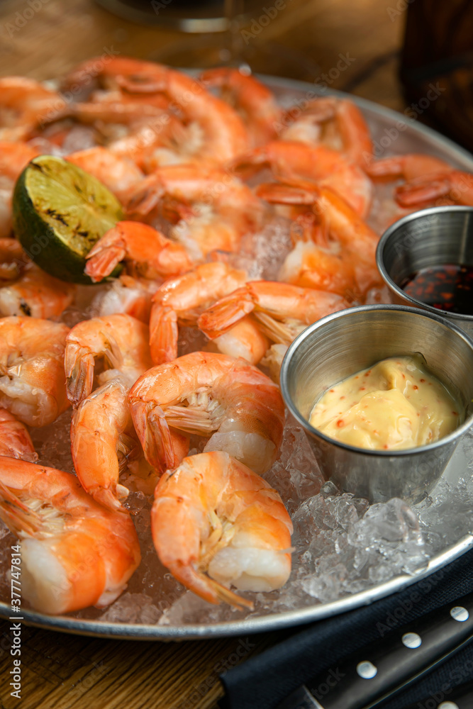 Boiled shrimp from the menu of an American restaurant. On a wooden table
Boiled shrimp from the menu of an American restaurant. On a wooden table