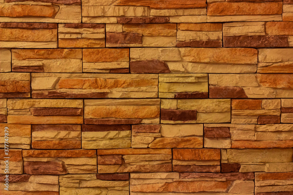 background of orange brick wall. Stone facing. Old yellow bricks background of orange brick wall. Stone facing. Old yellow bricks