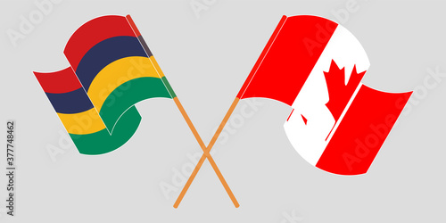 Crossed and waving flags of Mauritius and Canada