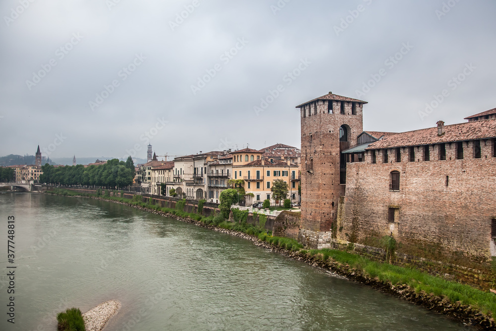 View from the Scaliger bridge of the Adige river, the Old castle, the bell tower of the Cathedral and the Cathedral of St. Anastasia in Verona. Veneto, Italy View from the Scaliger bridge of the Adige river, the Old castle, the bell tower of the Cathedral and the Cathedral of St. Anastasia in Verona. Veneto, Italy