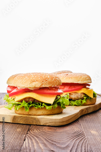 Burgers on wooden serving board