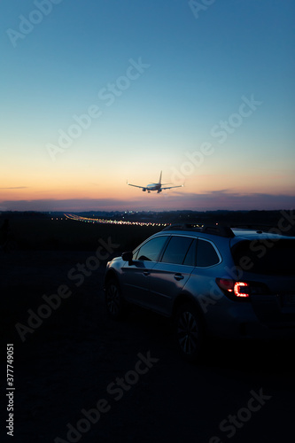 view of the car with taillights airplane landing on background © phpetrunina14