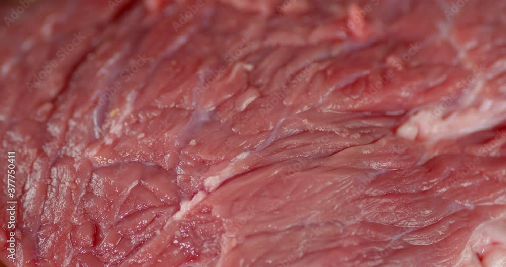 Fresh raw beef rotating slowly. Macro background. Fresh raw beef rotating slowly. Macro background.