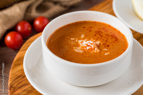 Tomato soup with cheese in white porcelain bowl.