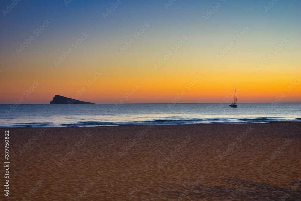 Sunset with sailboat at Benidorm