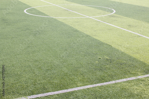 Obraz na płótnie Photo of a green synthetic grass sports field with white line shot from above. w salonie