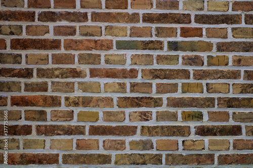 Texture of old brick wall with multicolored bricks