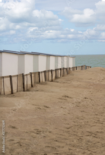 Beach houses on deserted sea shore blue sky