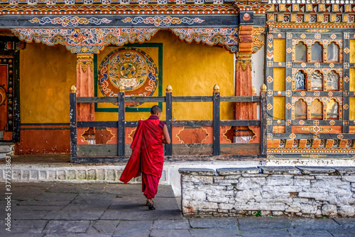 Bhutan, Paro, inside Rinpung Dzong. Silhouette of a monk in his red dress .