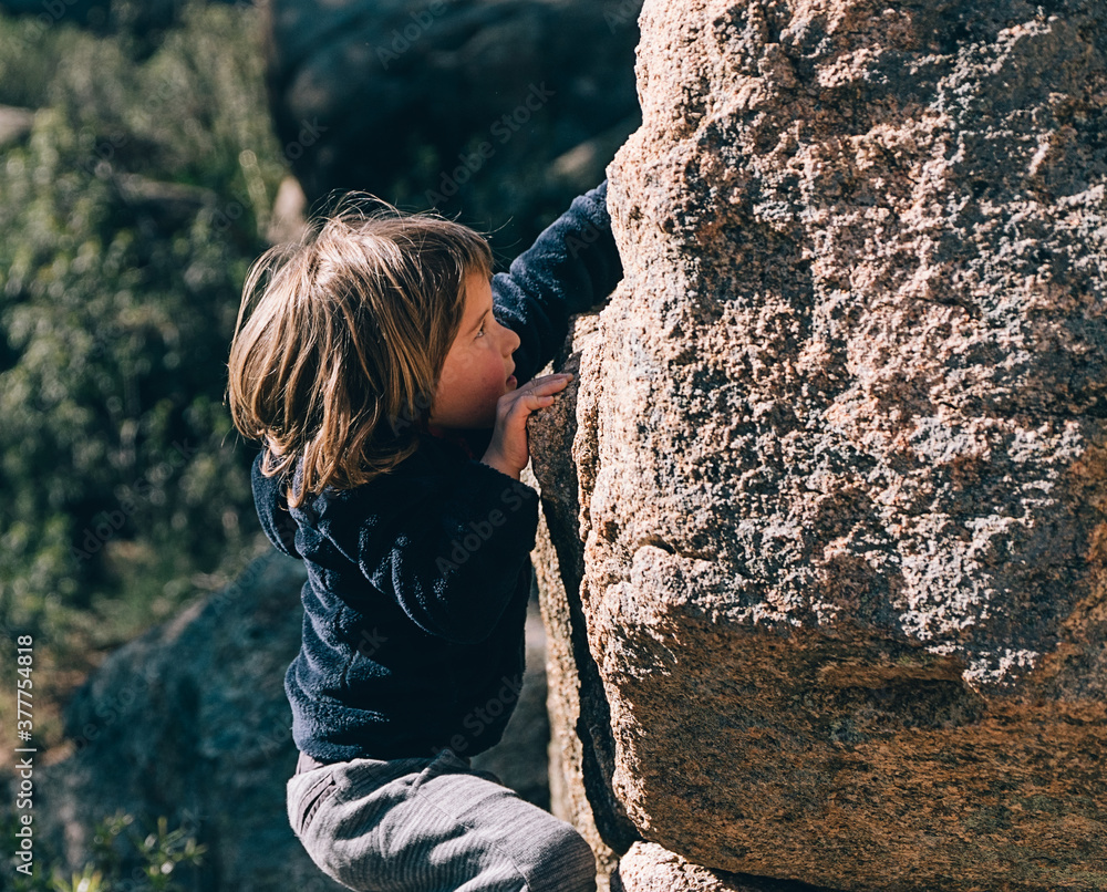 Cute Little Girl Climbing Rock